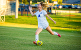  soccer player kicking a ball